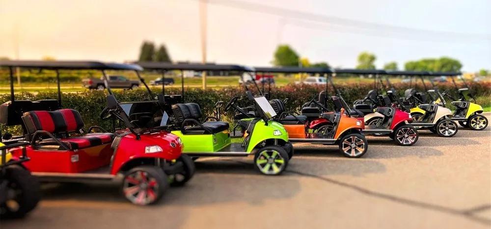 Line of colorful custom golf carts